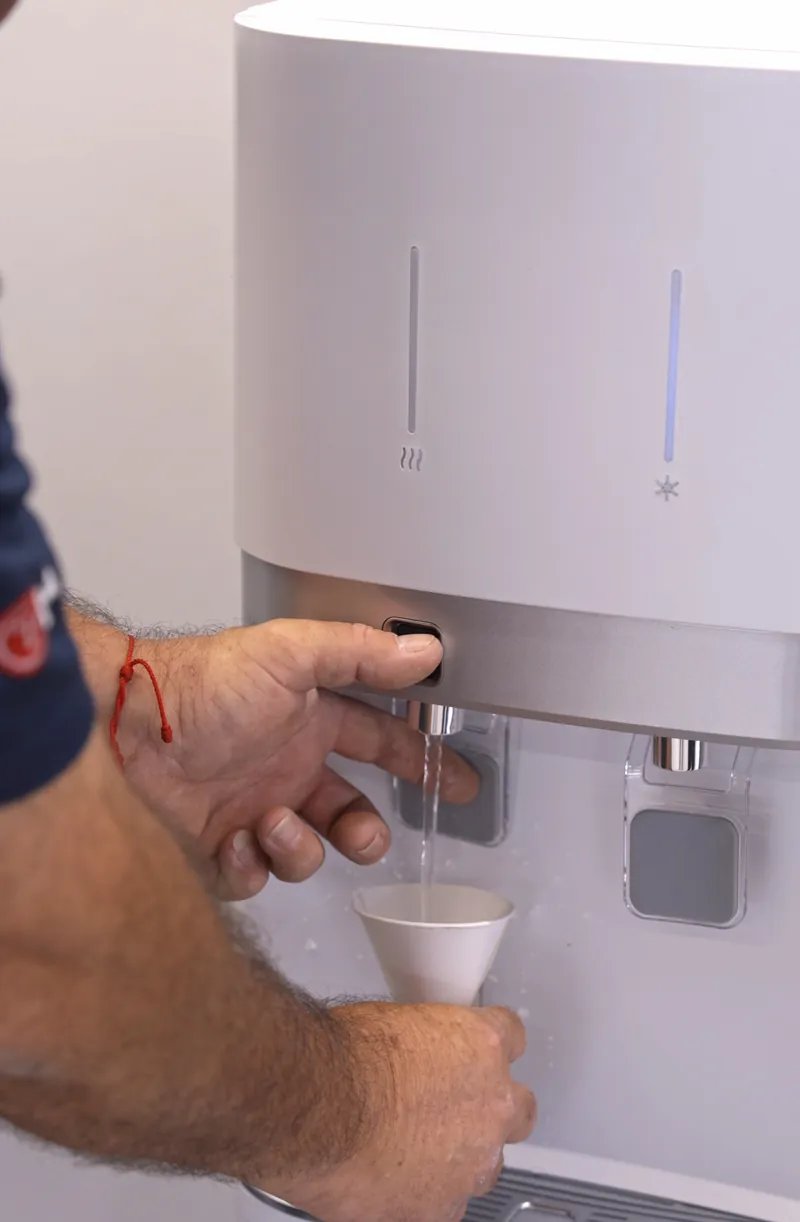 Dispense step for a bottleless water cooler